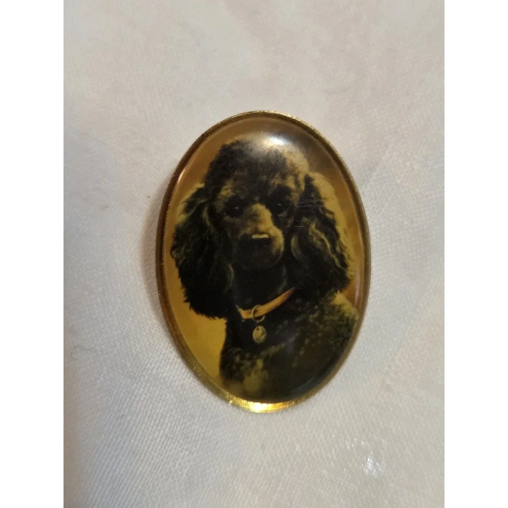 vintage Otter House lapel pin featuring a portrait of a black poodle